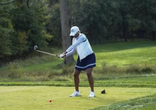 Woman golfing as CSU Golf classic.
